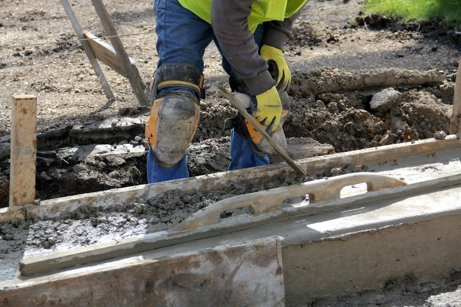 Knee pads in use on a concrete construction jobsite