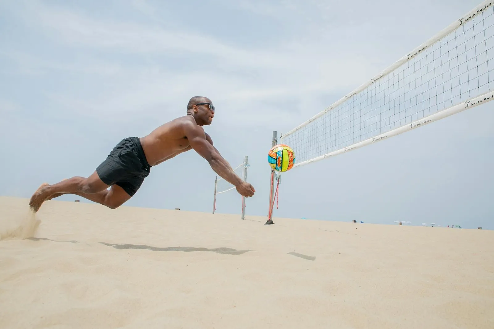 Volleyball player diving on court wearing low-profile knee pads